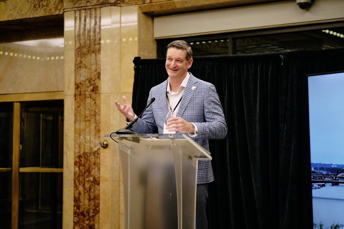 Jamie Rand of Downtown Revival Trust speaking at a podium